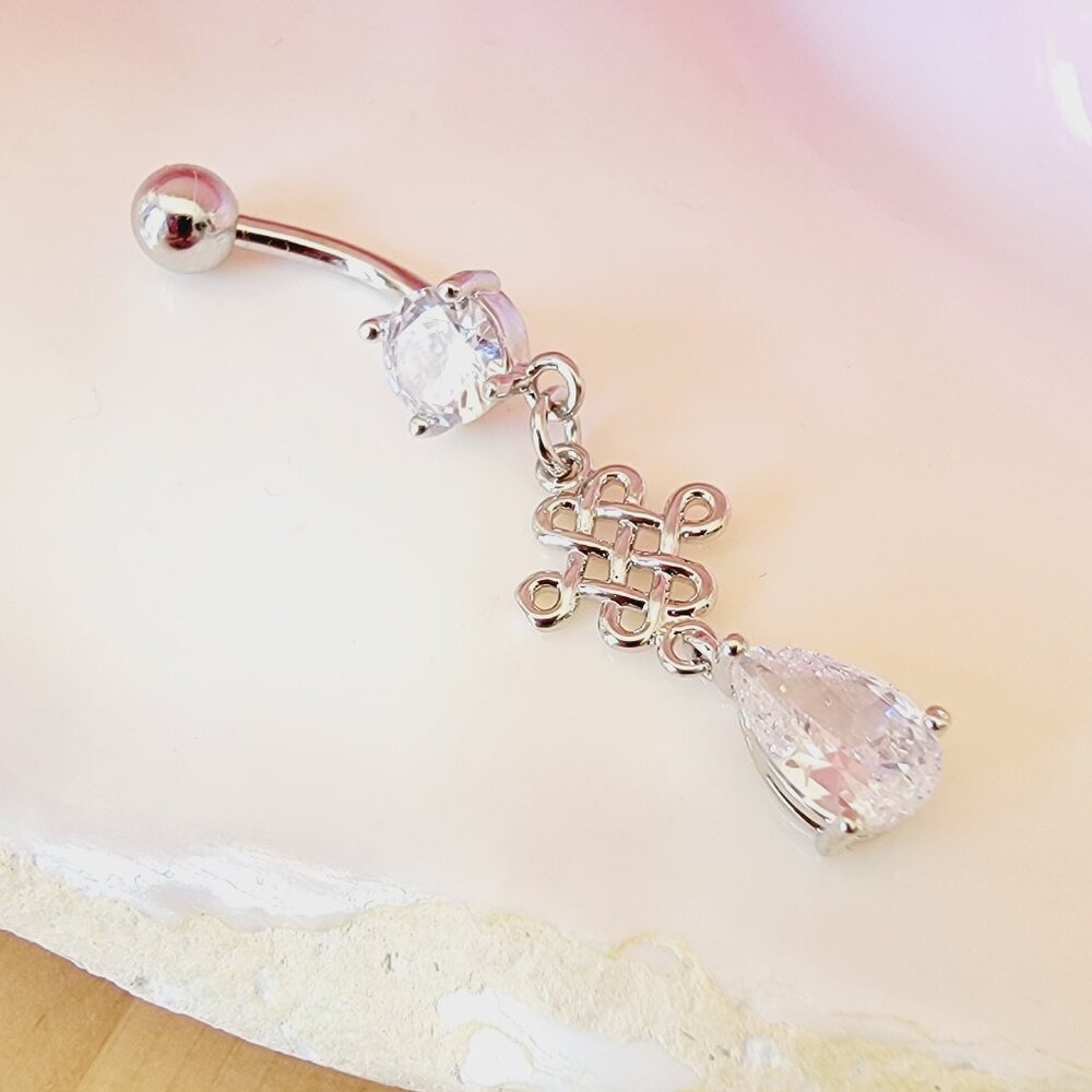 14G dangle belly button ring with decorative celtic shape charm in clear CZ